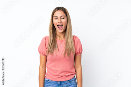 Young blonde woman over isolated white background shouting to the front with mouth wide open