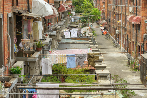 Typical, picturesque French concession quarter in old Shanghai, with hanging drying clothes and brick buildings. photo