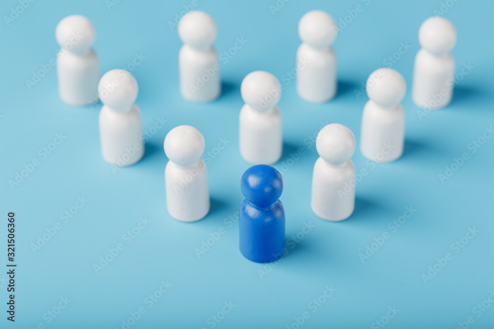 The leader in blue leads a group of white employees to victory, HR, Staff recruitment. The concept of leadership. The leader in blue leads a group of white employees to victory, HR, Staff recruitment. The concept of leadership.