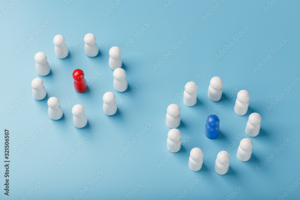 Two different Groups of white people stand around the blue and red leadership candidates separately. Competition in business between the firms and the teams. Two different Groups of white people stand around the blue and red leadership candidates separately. Competition in business between the firms and the teams.