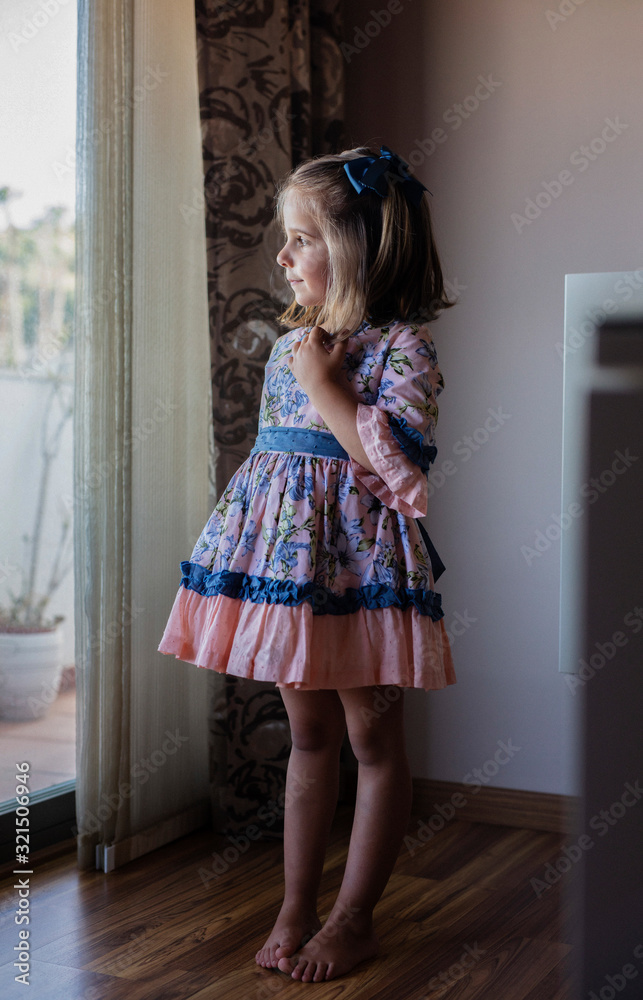 young girl looking out the window in her house,lifestyle young girl looking out the window in her house,lifestyle