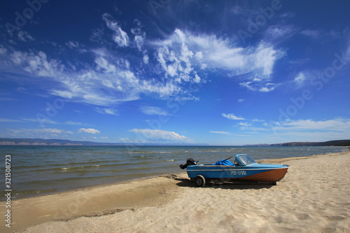 Lake Baikal, Olkhon island, a nature reserve, with its sandy Bay, summer, boat