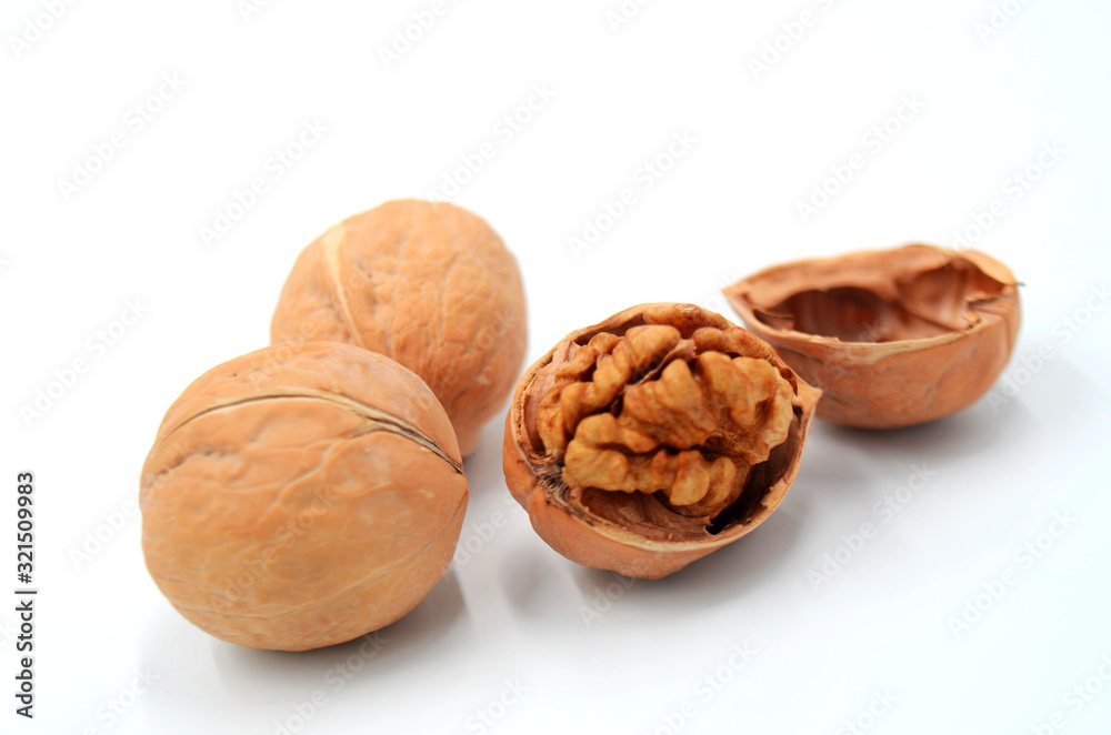 Peeled walnuts on a white indoor background Peeled walnuts on a white indoor background