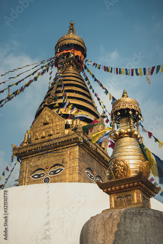 Buddhist building, the Swayambhunath Stupa or monkey temple during the day and its prayer flags fluttering in the wind, Nepal, Kathmandu