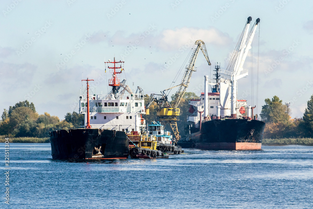 two bulk carriers re-unload on a river raid
