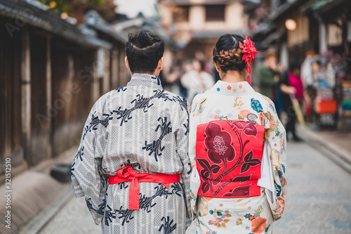Young women wearing traditional Japanese Kimono with colorful maple trees in autumn is famous in autumn color leaves and cherry blossom in spring, Kyoto, Japan.