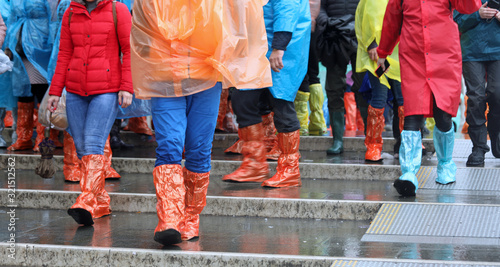 group of people with colored plastics leggings while raining © ChiccoDodiFC