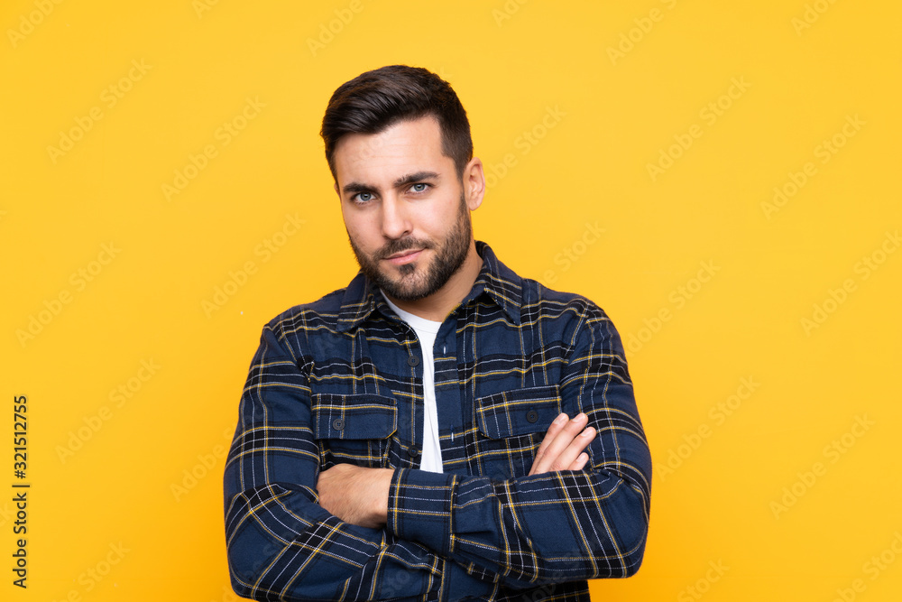 Fototapeta premium Young handsome man with beard over isolated yellow background feeling upset