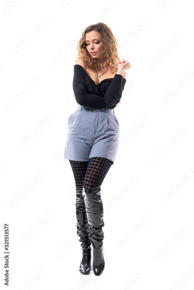 Sad mindful beautiful curly hair brunette woman in stylish clothes looking down thinking. Full body length isolated on white background. Sad mindful beautiful curly hair brunette woman in stylish clothes looking down thinking. Full body length isolated on white background.