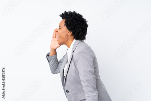 African american business woman over isolated white background shouting with mouth wide open