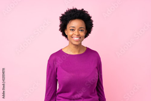 African american woman over isolated pink background laughing