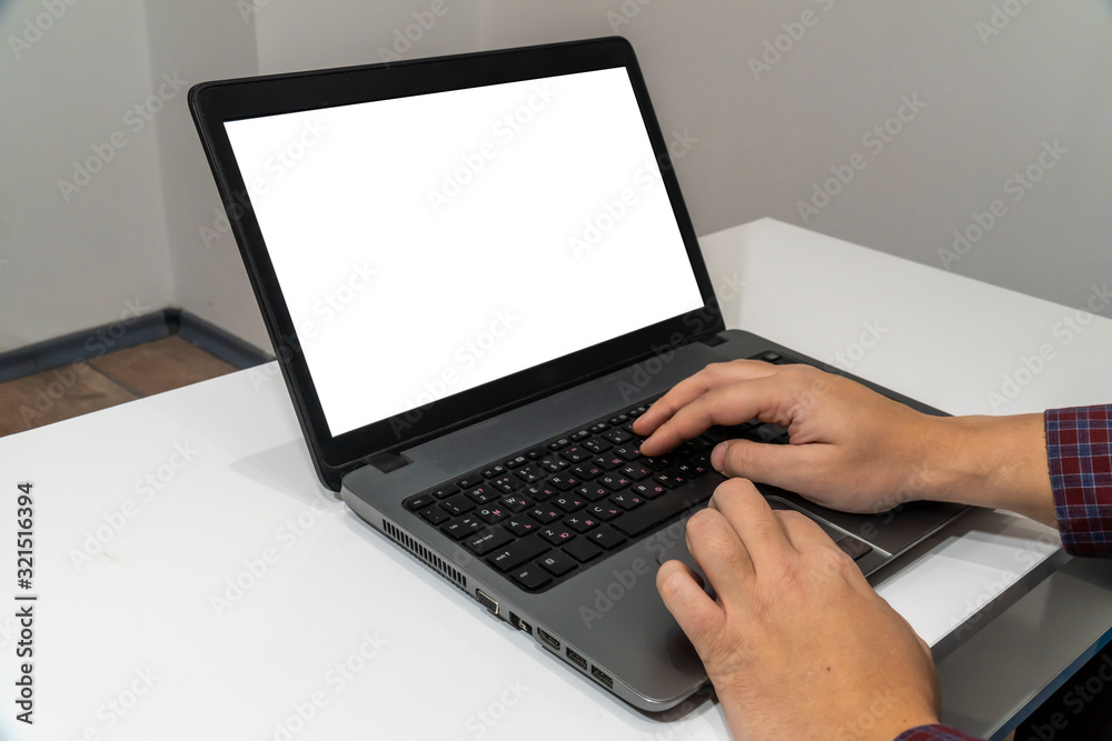 Above view of man typing on a laptop Above view of man typing on a laptop