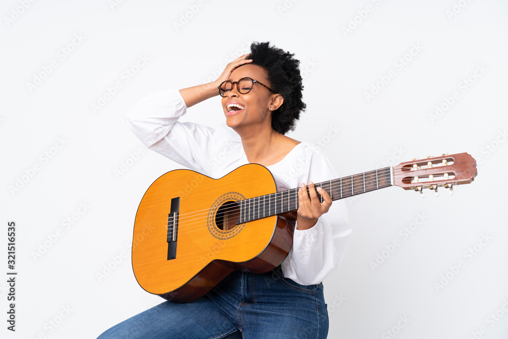 African american woman with guitar over isolated background has realized something and intending the solution