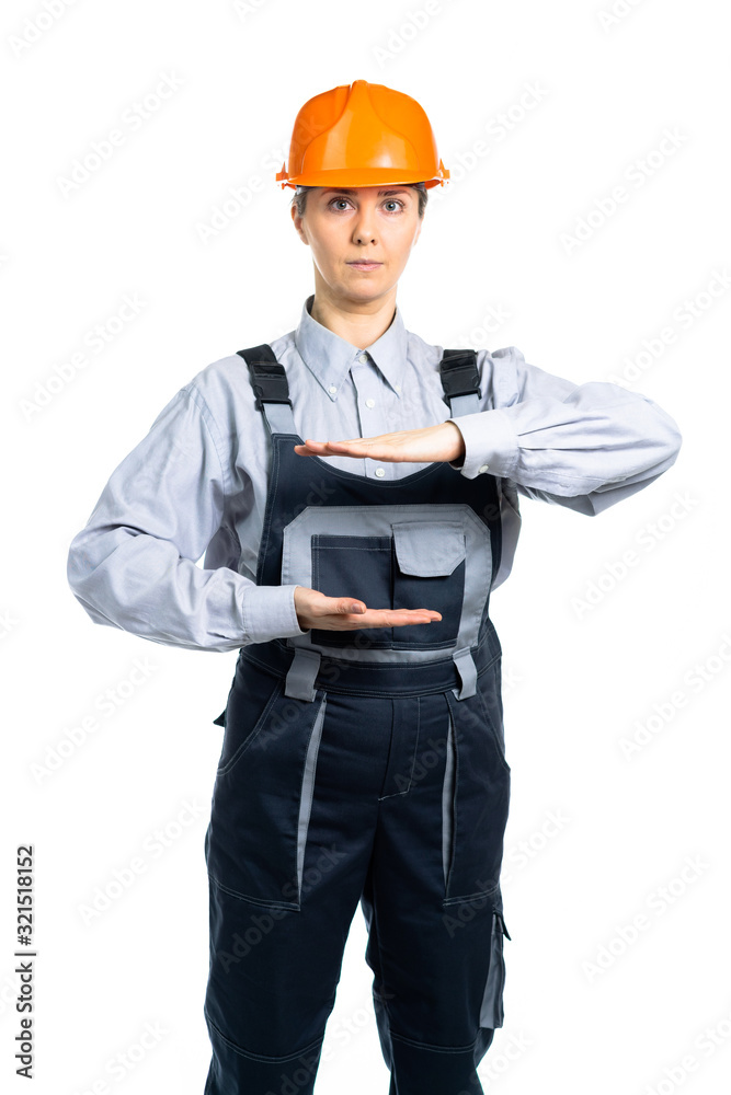 Female engineer builder is holding a blank for his text with his hands in front of him. Isolated Female engineer builder is holding a blank for his text with his hands in front of him. Isolated