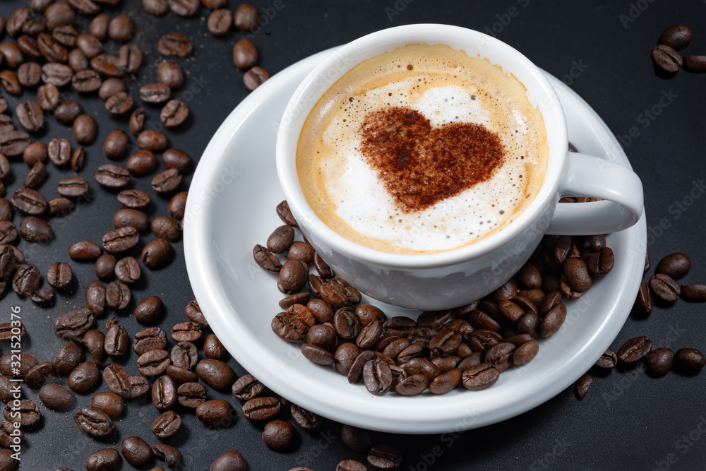 Valentine day,Topping sweet heart white cup of coffee and spread coffee beans on Valentine day,Topping sweet heart white cup of coffee and spread coffee beans on