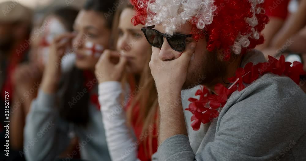 English football fans feeling disappointed and crying after defeat in a match. Disappointed England soccer supporters after a game lose.