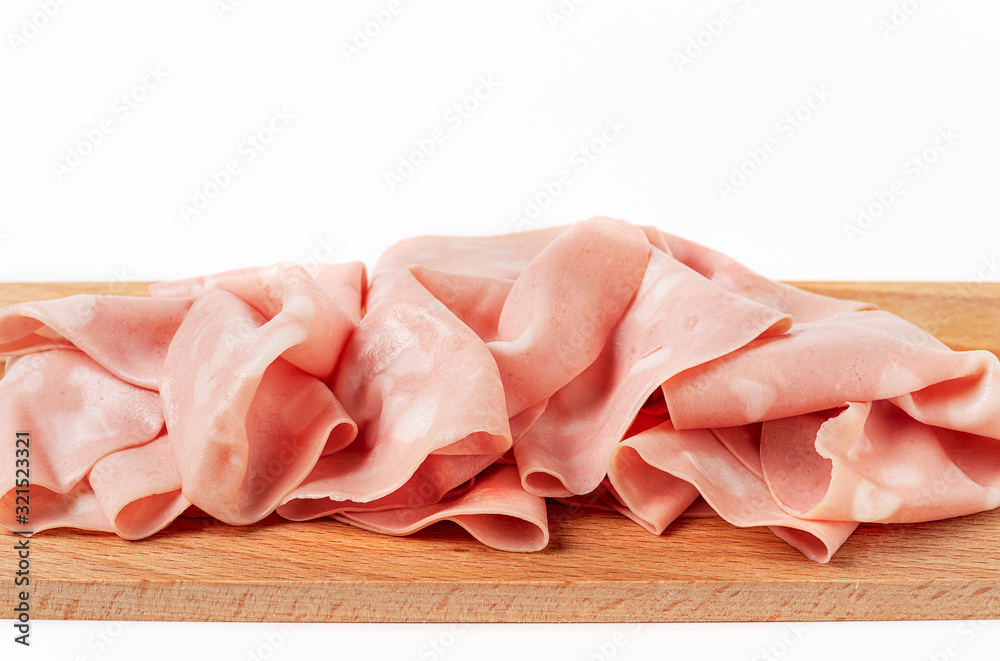 Front view of slices of mortadella chopping board on a white background Front view of slices of mortadella chopping board on a white background