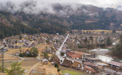 Traditional cottage houses in Shirakawago village with mountain hills in travel trip and holidays vacation in sunmer season, Gifu, Japan. Architecture landscape background. World heritage photo