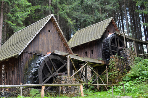 two old wooden water mill with mill-wheel detail photo