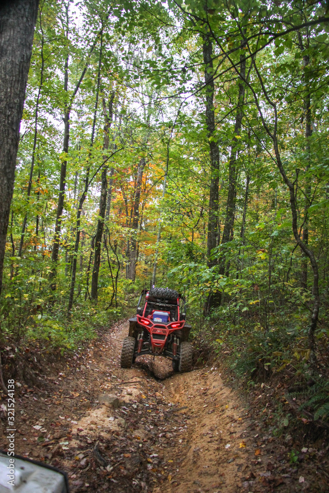 Buggie stradling trench on trail in woods of TN Buggie stradling trench on trail in woods of TN