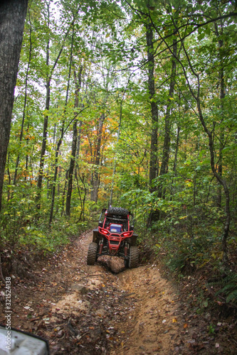 Buggie stradling trench on trail in woods of TN