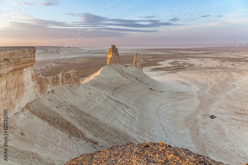 The Ustyurt Plateau. District of Boszhir. A group of tourists in cars stopped for the night. The bottom of a dry ocean Tethys. Rocky remnants. Kazakhstan. long shutter speed