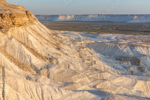 Sunrise over Ustyurt Plateau. District of Boszhir. The bottom of a dry ocean Tethys. Rocky remnants. Kazakhstan. selective focus