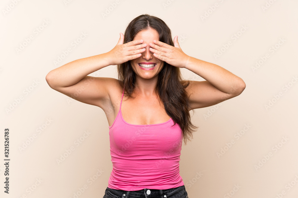 Young woman over isolated white background covering eyes by hands Young woman over isolated white background covering eyes by hands