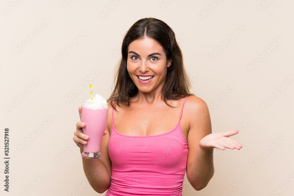 Young woman with strawberry milkshake with shocked facial expression Young woman with strawberry milkshake with shocked facial expression