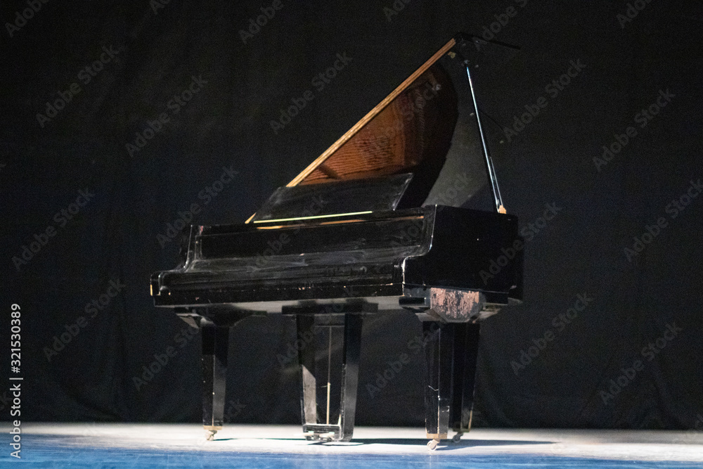 Fototapeta Piano on stage in a theater. Art. Performance. Classical music. Concert.
