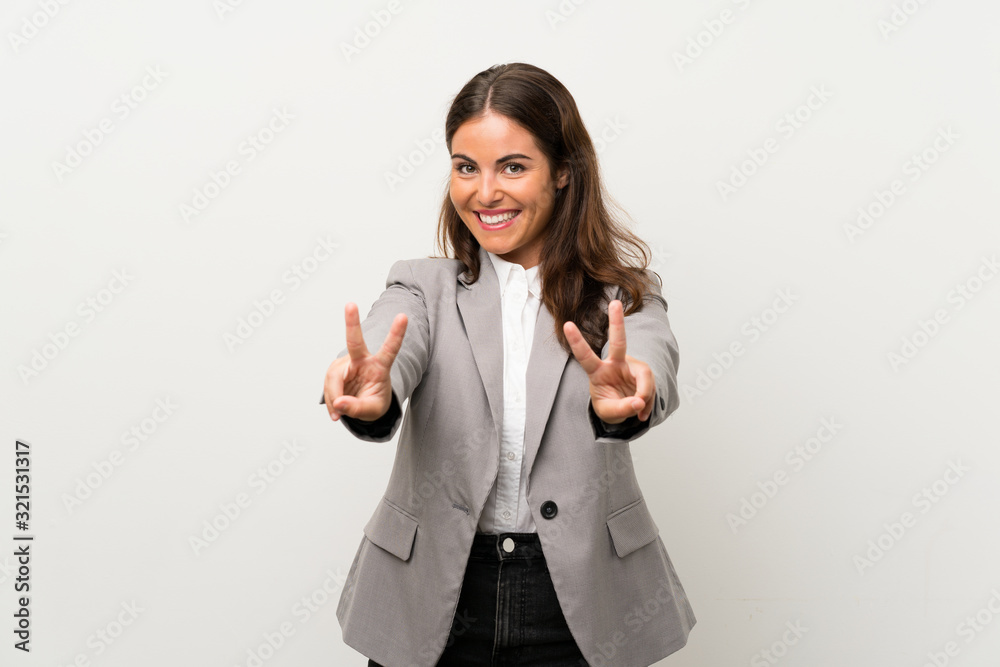Young business woman over isolated white background smiling and showing victory sign Young business woman over isolated white background smiling and showing victory sign