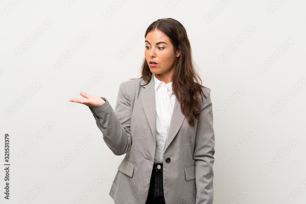 Young business woman over isolated white background holding copyspace imaginary on the palm Young business woman over isolated white background holding copyspace imaginary on the palm