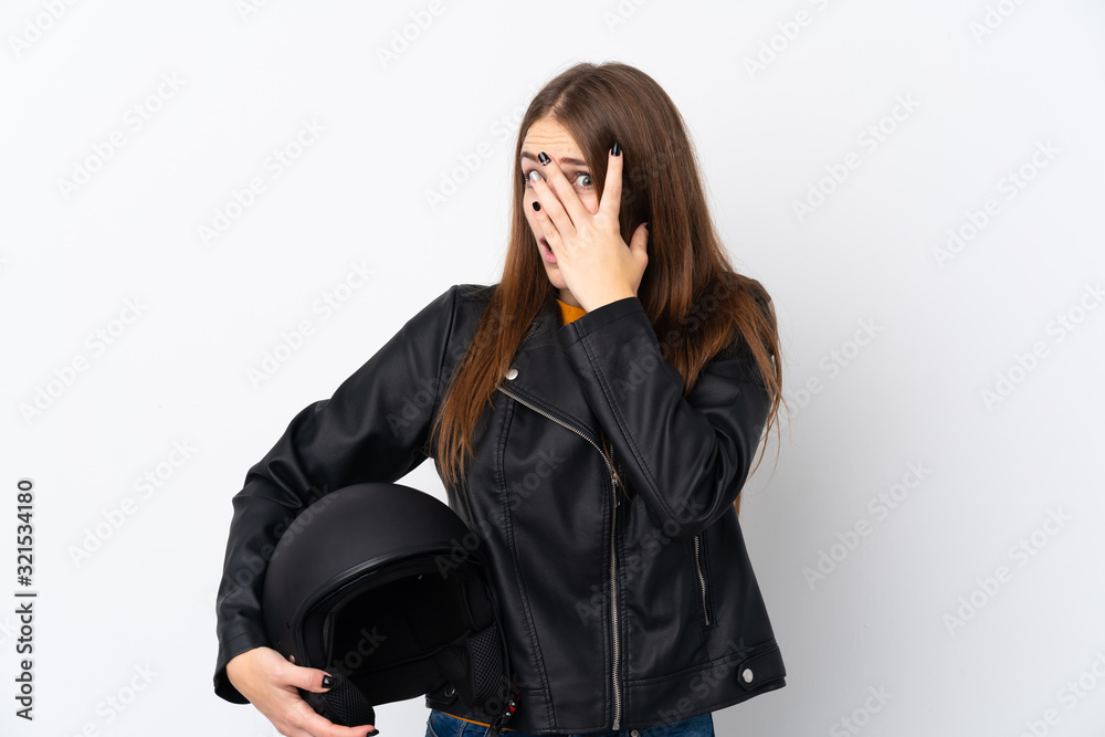 Woman with a motorcycle helmet covering eyes and looking through fingers Woman with a motorcycle helmet covering eyes and looking through fingers