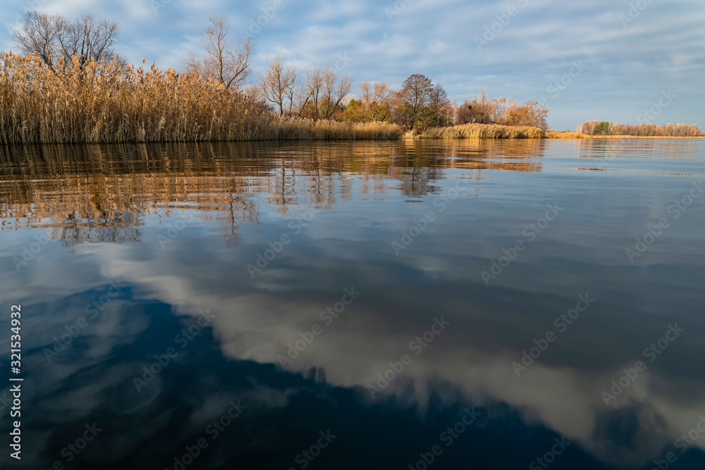 Early spring or late autumn at lake. Fishing landscape background with copy space