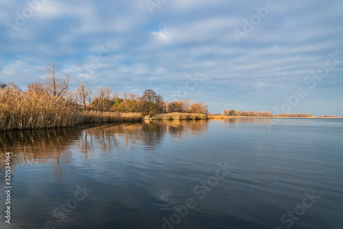 Early spring or late autumn at lake. Fishing landscape background with copy space © FedBul