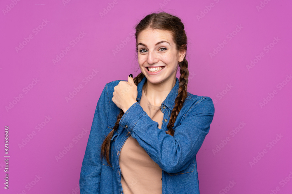 Young woman over isolated purple background celebrating a victory Young woman over isolated purple background celebrating a victory