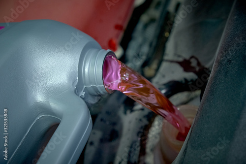Antifreeze in the car. filling the glass of water