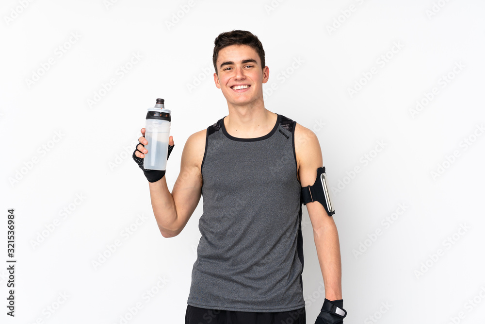Teenager sport man over isolated white wall with sports water bottle Teenager sport man over isolated white wall with sports water bottle