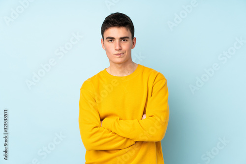 Teenager caucasian handsome man isolated on purple background feeling upset