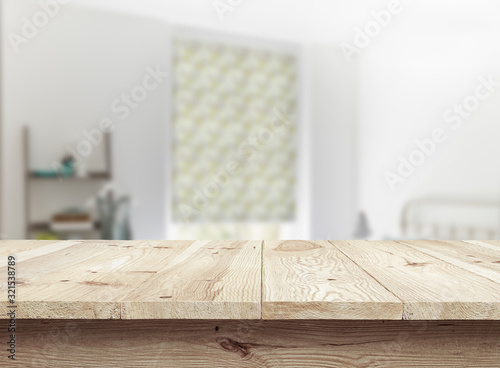 Wooden textured desk with blur interior background