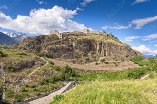 A panoramic view on the historic ruins of Castle Tourbillon in the city of Sion (Sitten) in Switzerland (Canton Wallis/Valais) under a wonderful blue sky with light clouds.