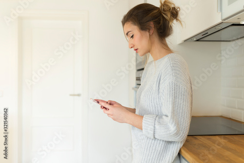 Young woman using smartphone at home