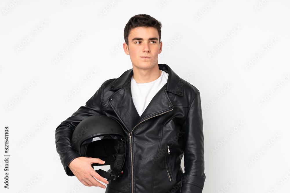 Man holding a motorcycle helmet isolated on white background thinking an idea Man holding a motorcycle helmet isolated on white background thinking an idea