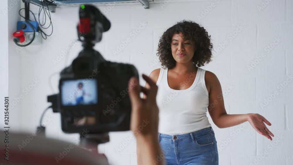Female Videographer Filming Woman Recording Podcast In Studio