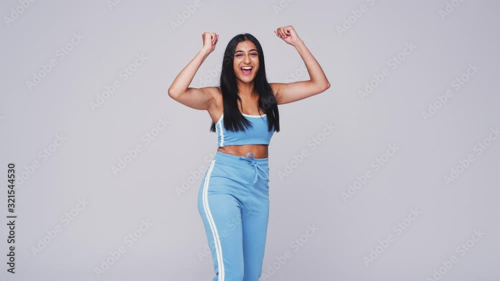 Wide Angle Studio Shot Of Young Woman Against White Background Dancing In Slow Motion Wide Angle Studio Shot Of Young Woman Against White Background Dancing In Slow Motion