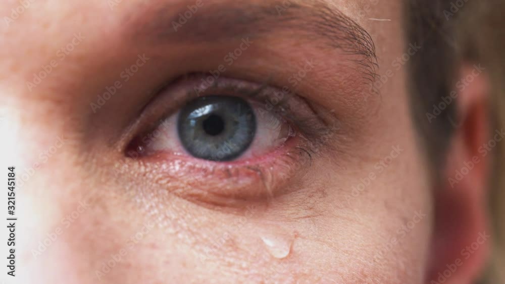 Extreme Close Up Of Eye As Unhappy Man Cries Into Camera In Studio