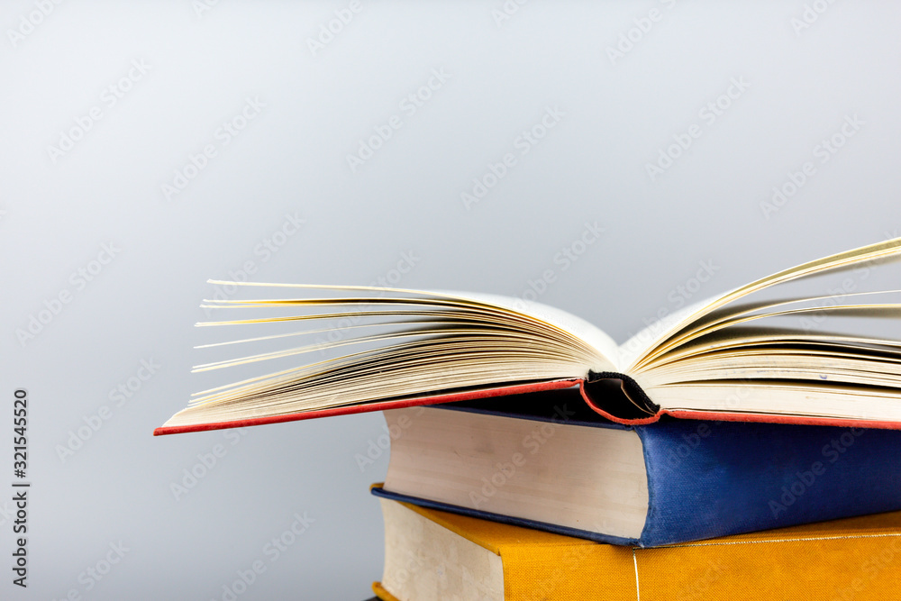 Naklejka premium Stack of old books on gray background