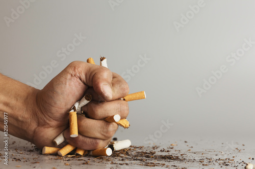 Hand fist smash or punch on cigarette.Cigarettes is addictive to be cancer.smoking reduction campaign in World No Tobacco Day.