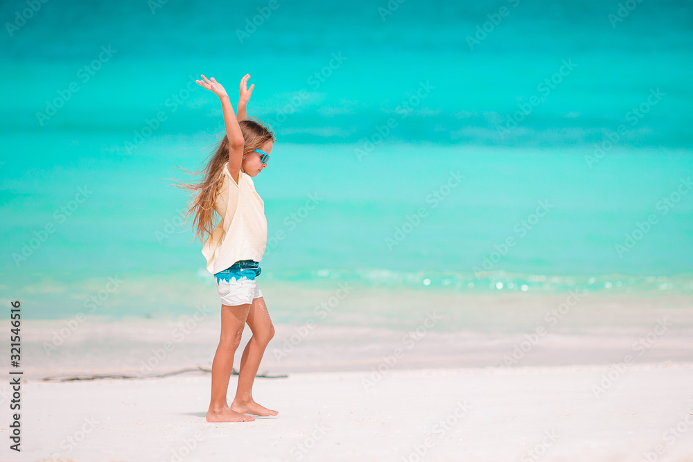 Portrait of adorable little girl at beach on her summer vacation Portrait of adorable little girl at beach on her summer vacation