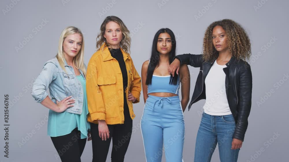 Studio Shot Of Young Independent Multi-Cultural Female Friends Looking Into Camera In Slow Motion